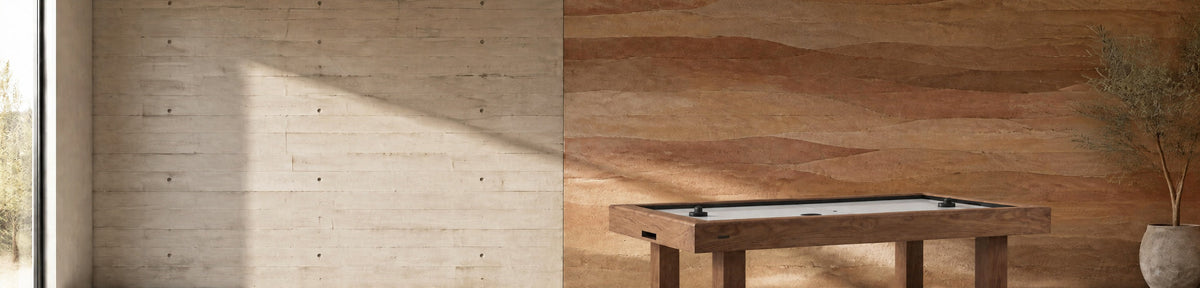 11 Ravens Malibu Air Hockey Table in a modern games room with a stamped concrete wall