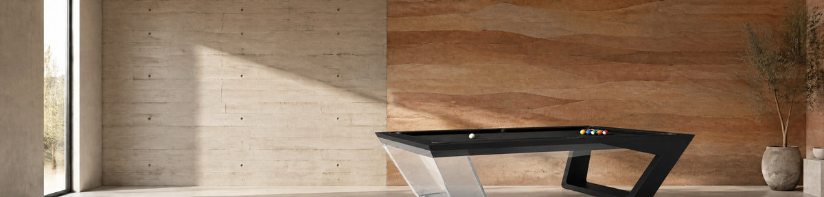 11 Ravens Avettore Lucite Pool Table in a modern games room with a stamped concrete wall