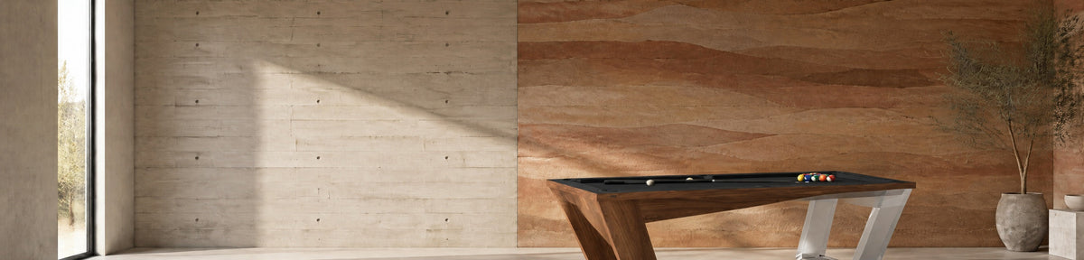 11 Ravens Avettore Lucite Pool Table in a modern games room with a stamped concrete wall