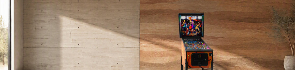 Quetzal Super Hoop Pinball Machine in a modern games room with a stamped concrete wall