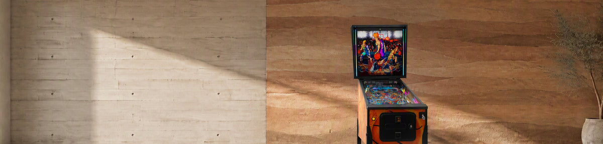 Quetzal Super Hoop Pinball Machine in a modern games room with a stamped concrete wall