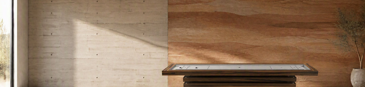 11 Ravens Macan Shuffleboard Table in a modern games room with a stamped concrete wall